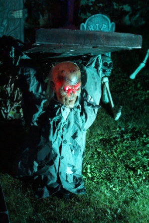 Zombie lifting tombstone